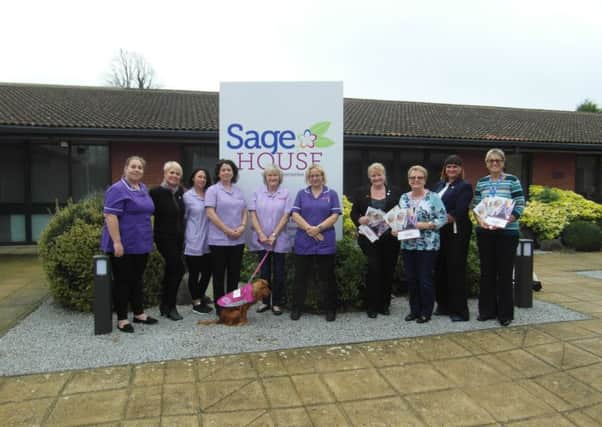The Guardian Angel carers with Bella the dog mascot outside Saga House