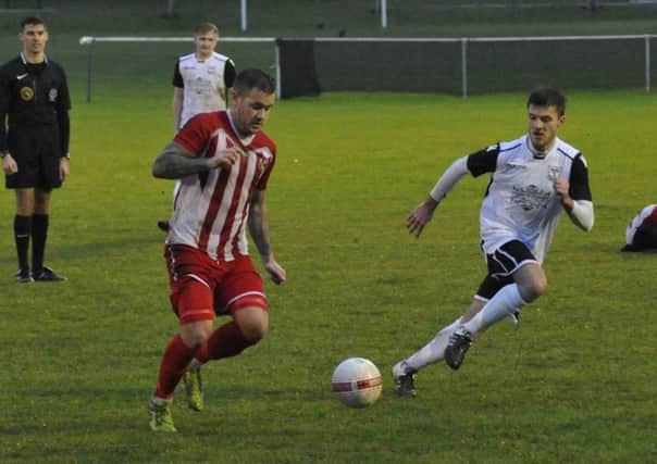 Bexhill United midfielder Sammy Bunn keeps a close eye on the Steyning Town player in possession at The Polegrove last weekend. Picture by Simon Newstead