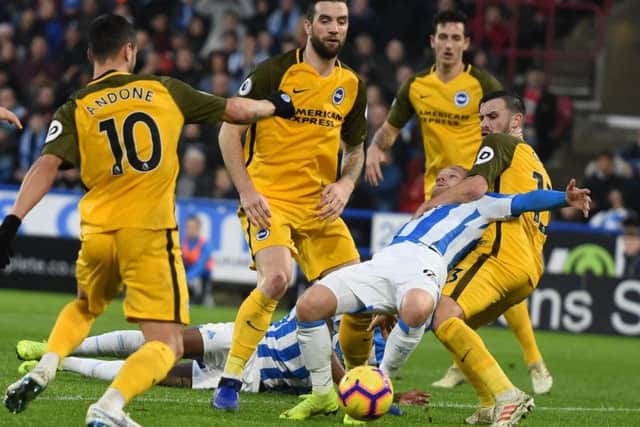 Alex Pritchard goes down under a Pascal Gross challenge. Picture by PW Sporting Photography