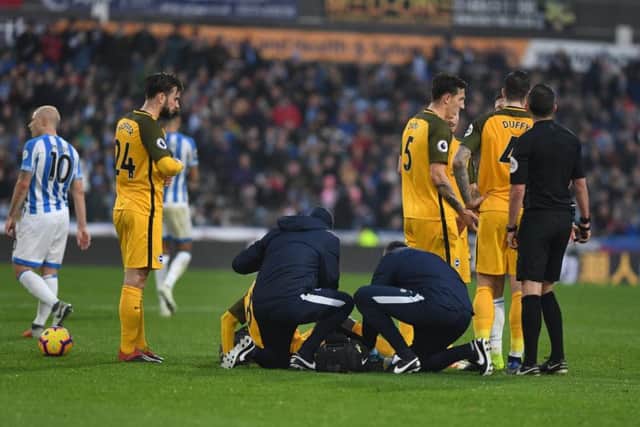 Yves Bissouma receives treatment after Steve Mounie's challenge on him resulted in a red card. Picture by PW Sporting Photography