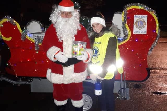 Sydney Colburn with Santa and his sleigh, out collecting with Adur East Lions Club