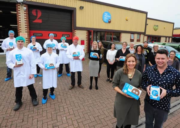Founders of The Protein Ball Co. Matt and Hayley Hunt, front, with the team outside their headquarters in Worthing. Picture: Kate Shemilt ks171097-1