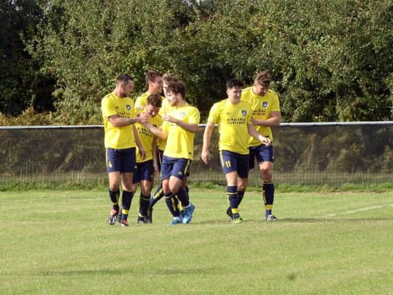 Sidlesham celebrate a goal earlier in the season  -and they won at Billingshurst last weekend / Picture by Kate Shemilt