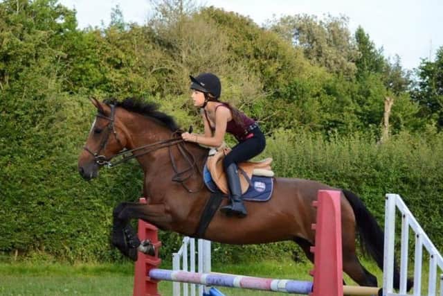 Maria Beves, 19, showjumping with Garbo before the attack