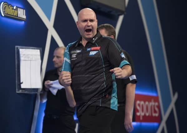 Rob Cross celebrates during his second round victory over Jeffrey De Zwaan at the William Hill World Darts Championship. Picture courtesy Lawrence Lustig/PDC