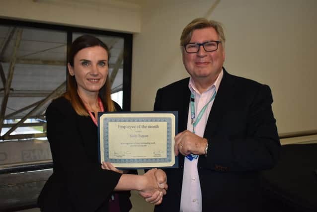 Kelly is pictured receiving her award from ESHT chairman David Clayton-Smith
