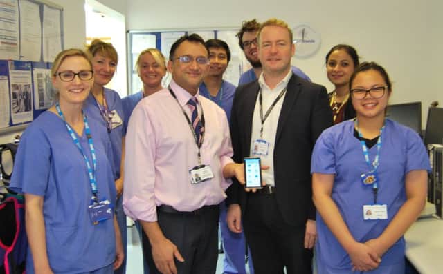 Professor Nikhil Patel Consultant Cardiologist holding smartphone with

Dr Richard Veasey Consultant Cardiologist and some of the cardiology team SUS-181217-103113001