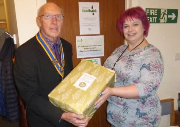 Club president Bruce Green with Samantha Gouldson, the deputy coordinator of the Foodbank