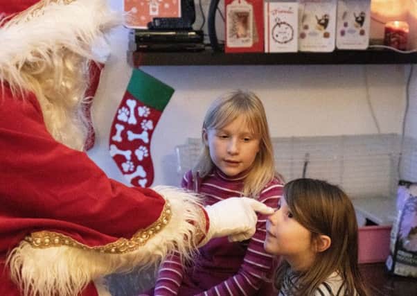 Megan, eight, and Michaela, four, had a special visit from Santa Claus.