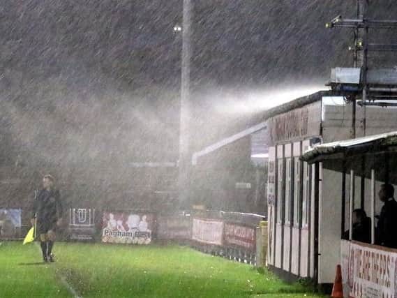 Rain hits Nyetimber Lane during a recent game versus Peacehaven - and there's been more of the same today / Picture by Roger Smith