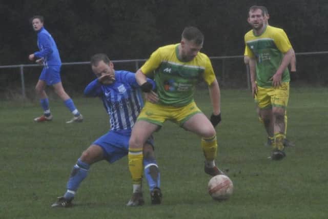 Midfield action from a wet, breezy and bitterly cold Parish Field on Saturday