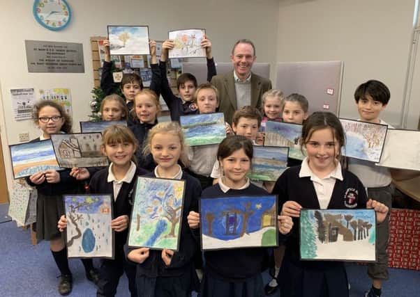 ick Herbert with the young artists from St Marys CE Primary School, Pulborough.  Taylor Young, with her winning painting, is on the far left. SUS-181219-110452001