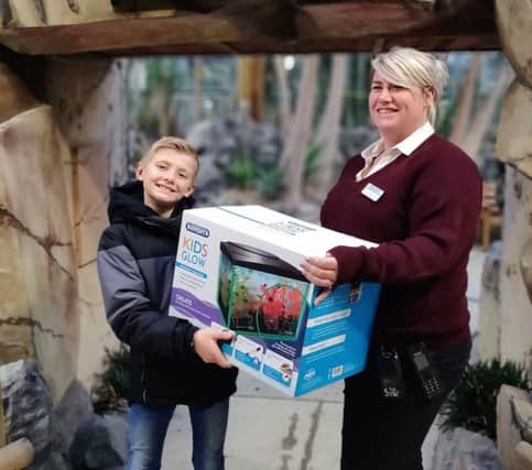 Daniel 'Shrimpy' Macdiarmid collects the donated fish tank from Sian Cummings at Paradise Park