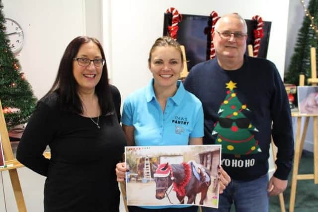 Patients Tania House and David Devonport with Joanne Moxon from Paws Pantry and the winning picture