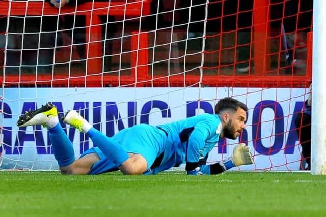 Crawley Town goalkeeper Glenn Morris made some vital saves.
Picture by Steve Rodrigues
