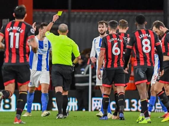 Lewis Dunk is booked by Mike Dean. Picture by PW Sporting Photography