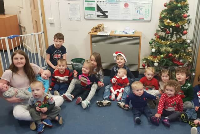 Toddlers at Munchkins Parent, Baby & Toddler group await their meting with Santa