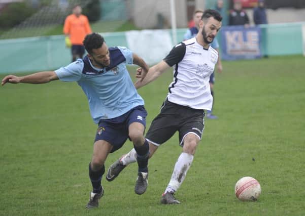 Bexhill United wide player Jack McLean dispossesses Hailsham Town full-back Andy Saunders. Pictures by Simon Newstead