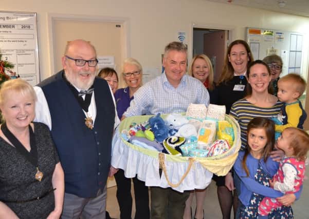 Cathy Peckham, her children and midwives at Worthing Hospital tell Tim Loughton MP about the Baby Basics project