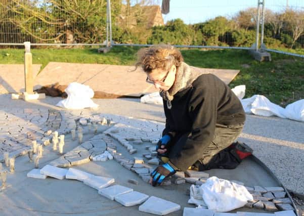 Jane Fordham works on the mosaic foundation