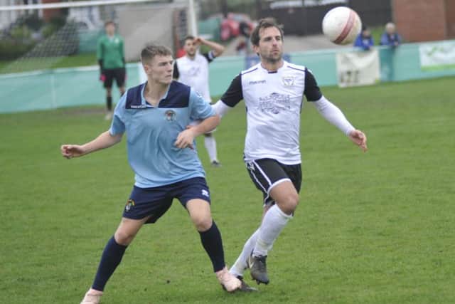 Chris Rea gets to the ball before a Hailsham Town opponent