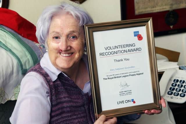 DM17112551a.jpg Poppy Appeal collector Daphne Snowden with her volunteering recognition award. Photo by Derek Martin Photography. SUS-171114-181957008