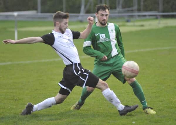 Bexhill United stretches to make a block during the 2-1 win at home to Mile Oak. Pictures by Simon Newstead