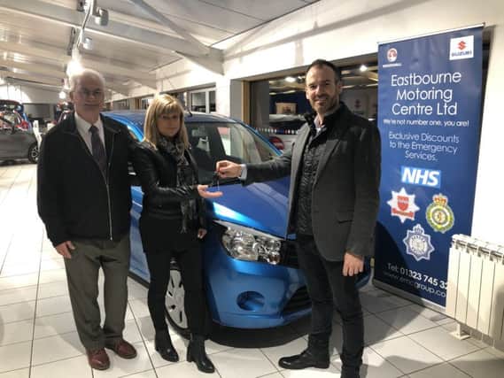 Bill Plumridge and Ollie Hodges, director of EMC, presenting the car to Denise Jeffreys SUS-190901-131031001