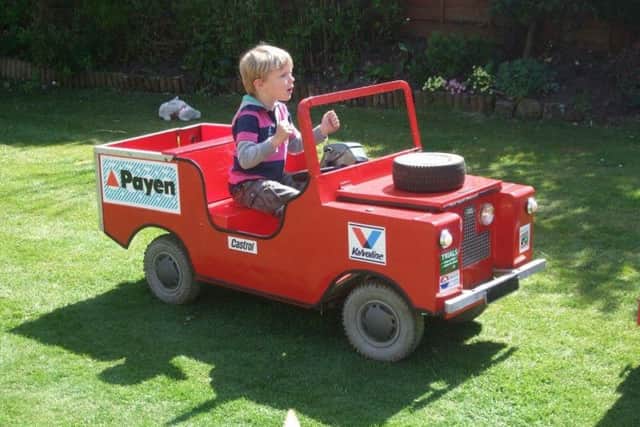 The red Land Rover being driven by grandson Sam when he was younger