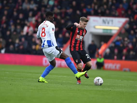 Yves Bissouma closes down Bournemouth midfielder Kyle Taylor. Picture by PW Sporting Photography