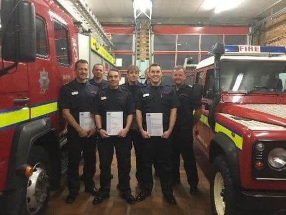 Firefighters with their certificates