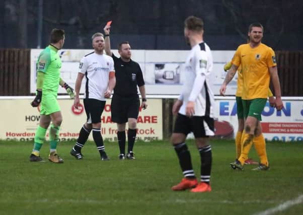 Faversham Town v Horsham - Charlie Goodger is shown a straight red car. Picture by John Lines