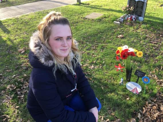 Natalie Pearson, 25, next to her son Louis' grave in Littlehampton Cemetery