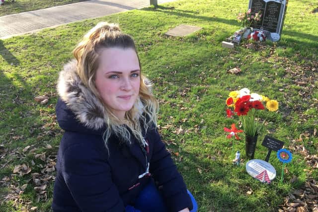 Natalie Pearson, 25, with the grave of her son Louis in Littlehampton Cemetery