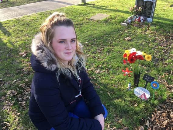 Natalie Pearson, 25, with the grave of her son Louis in Littlehampton Cemetery