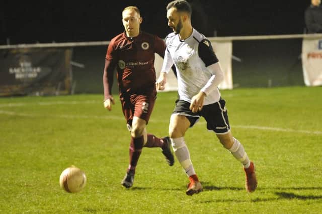 Bexhill United winger Jack McLean gets to the ball just ahead of Alfold full-back Gav Fowler