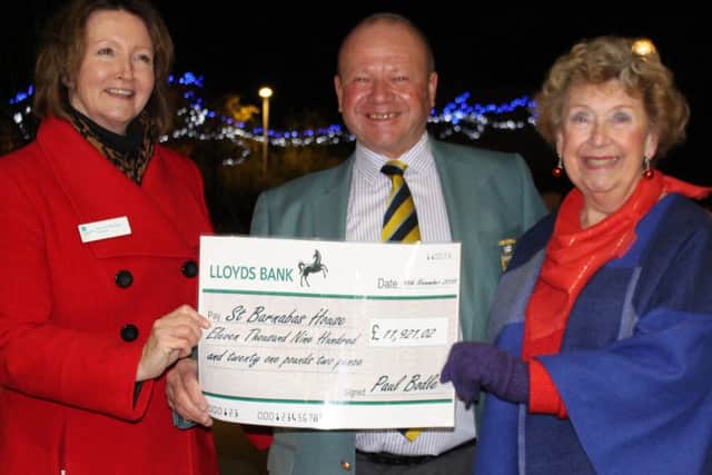 Jim Miller and Jill Howell, right, present the cheque to Patricia Woolgar at St Barnabas House