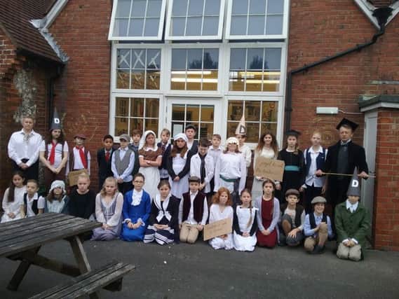 Pupils from years five and six in their period costumes with their Victorian teachers