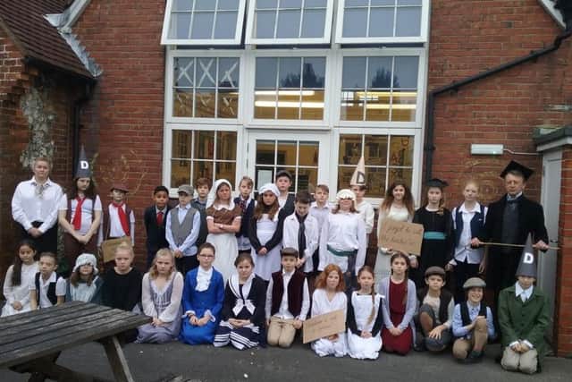 Pupils from years five and six in their period costumes with their Victorian teachers