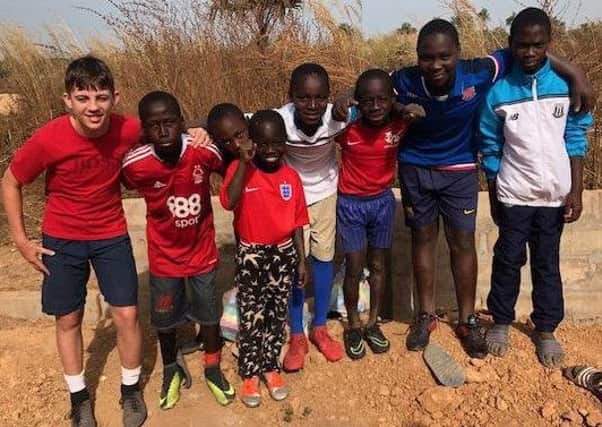 Children in the Gunjur village in Gambia who were fortunate to be given second hand football boots