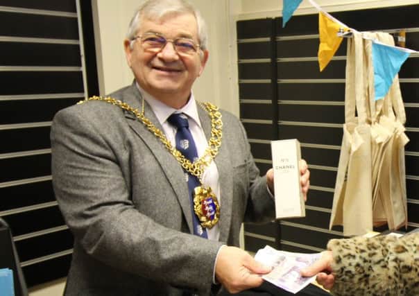 Hastings Mayor Cllr Nigel Sinden mans the till for the first sale at the Association of Carers new charity shop SUS-190115-101822001