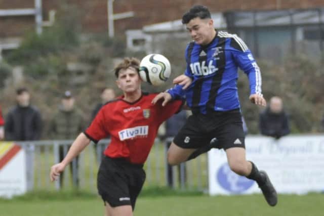 Hollington United and Sedlescombe Rangers compete for an aerial ball in midfield