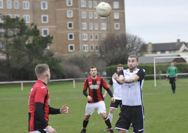 Bexhill United goalscorer Nathan Lopez heads the ball forward during the 1-1 draw with AFC Varndeanians. Picture by Simon Newstead