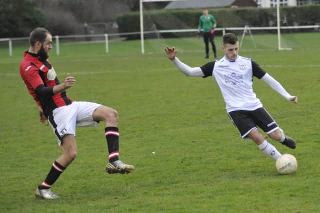 Bexhill United midfielder Jamie Bunn clips the ball down the line
