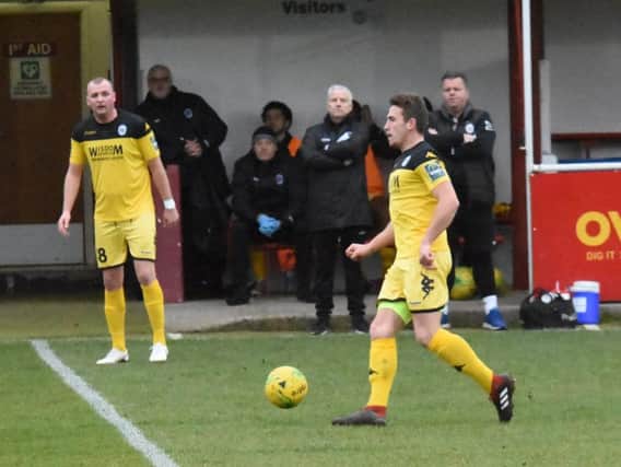 Karly Akehurst brings the ball out of defence against Hythe Town as Shaun Saunders watches on. Picture by Grahame Lehkyj