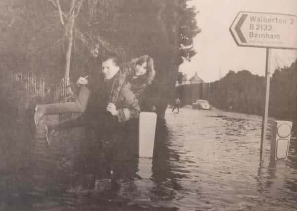 Gallant Philip Fogden gives Debbie Lawrence a lift through the flood at North End Road, near Barnham