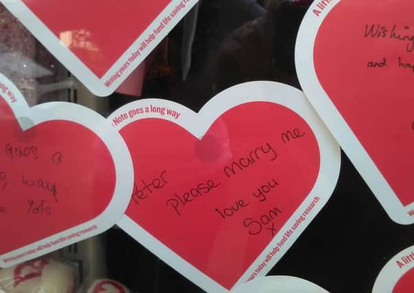 The wedding proposal note left in the window of the British Heart Foundation shop. SUS-180125-150431001