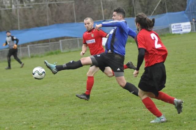 Hollington United forward Dominic Clarke tries to bring the ball under control against Sedlescombe Rangers