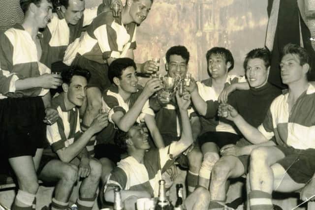 The Wigmore Athletic team celebrating in their dressing room in Culver Road. Ron is pictured behind the cup, with his brother Dom to the left.