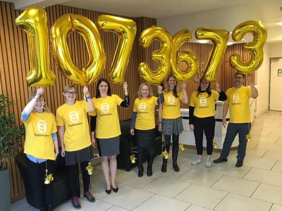 Staff at Sightsavers in Haywards Heath celebrate the huge donation
